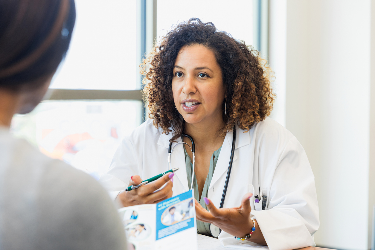 Female doctor discusses healthcare with patient