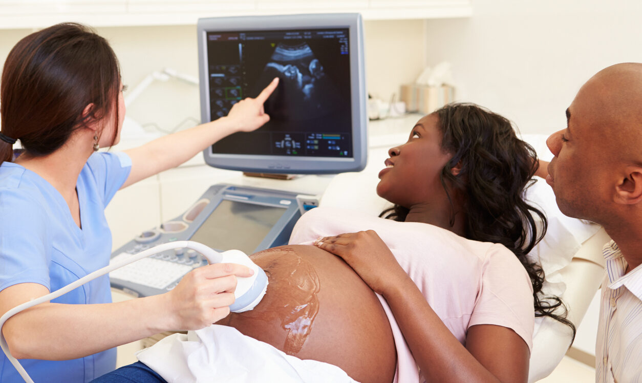 Pregnant Woman And Partner Having 4D Ultrasound Scan