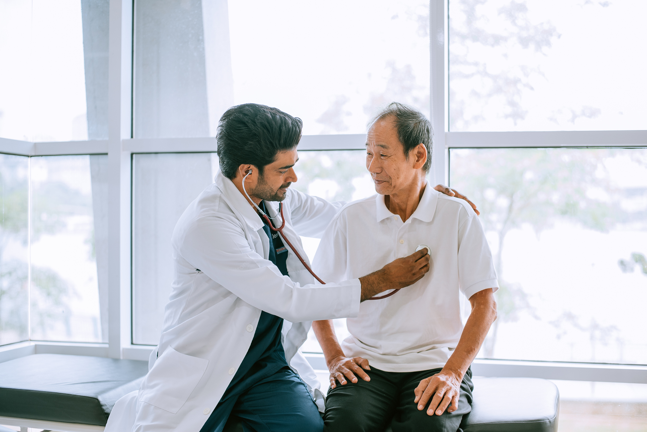 Shot of a doctor examining a patient with a stethoscope during a consultation in a hospital