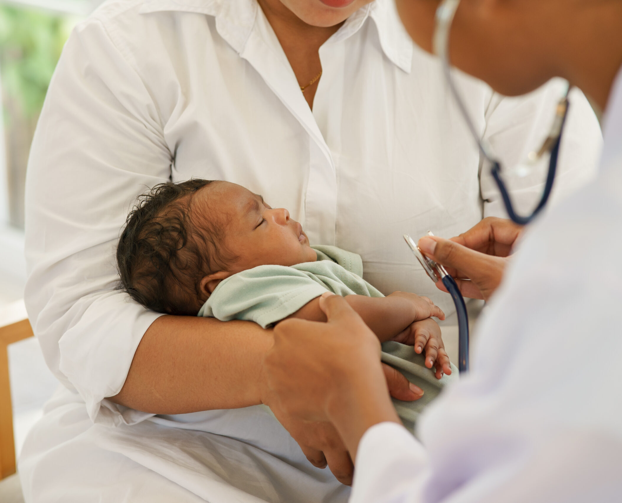 A newborn baby boy one-month-old mixed-race African-Thai, visiting the doctor for checkup health with stethoscope at the clinic pediatric. concept consultation, check-up, nurse, healing infant.