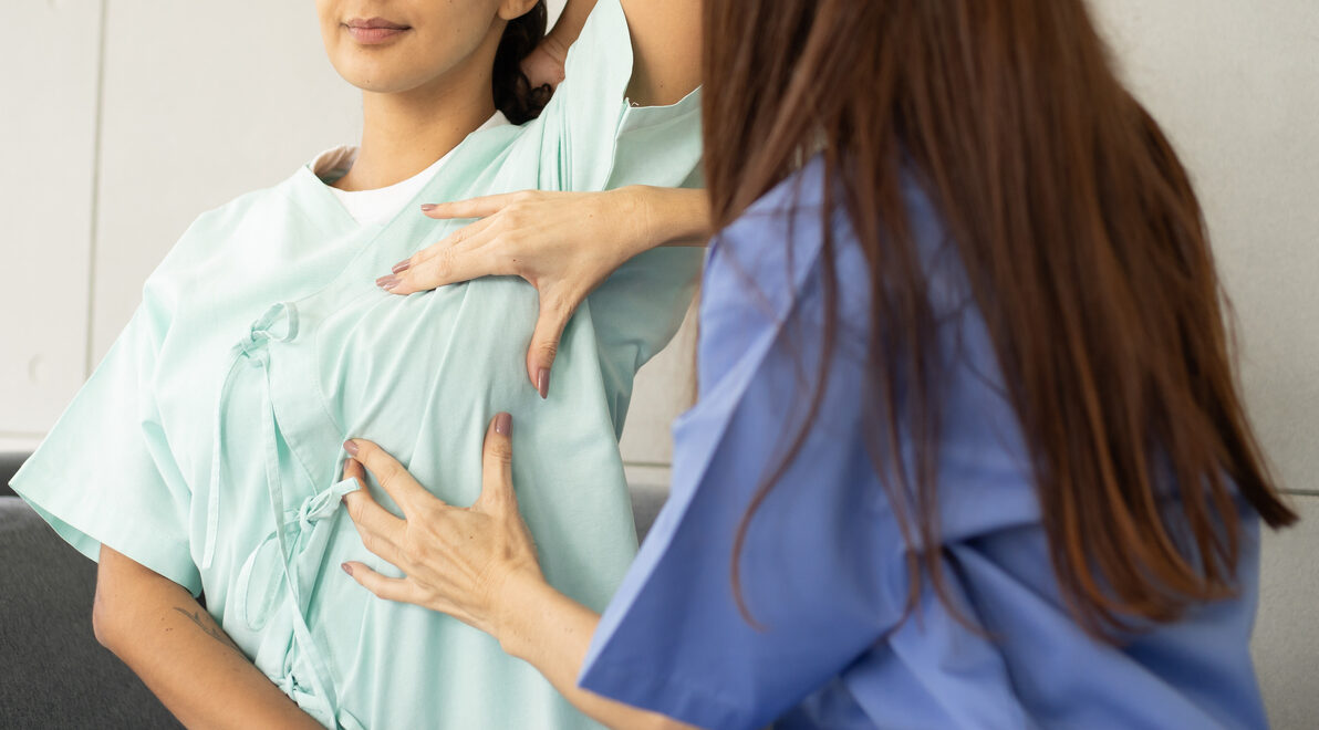 Young Hispanic adult patient girl in a Breast cancer medical screening exam for cancer prevention with a female doctor wearing the stethoscope.