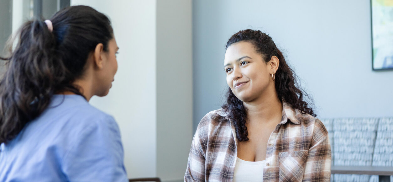 Young woman listens to female doctor