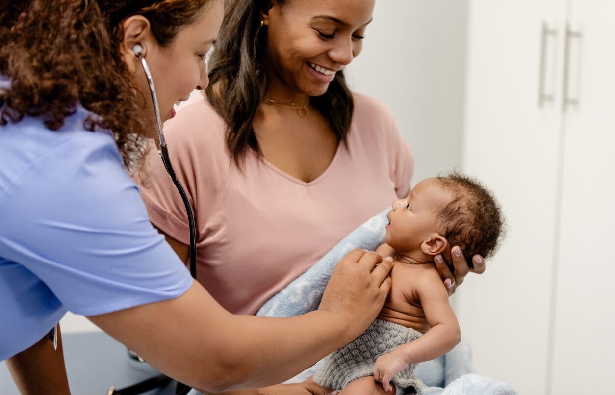 Doctor Examining Infant with Mother
