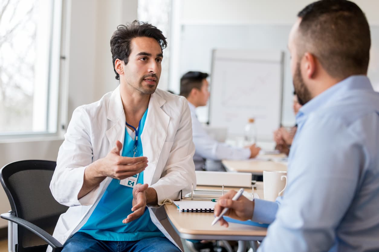 Doctor discussing treatment options with a patient during a healthcare consultation in a medical office