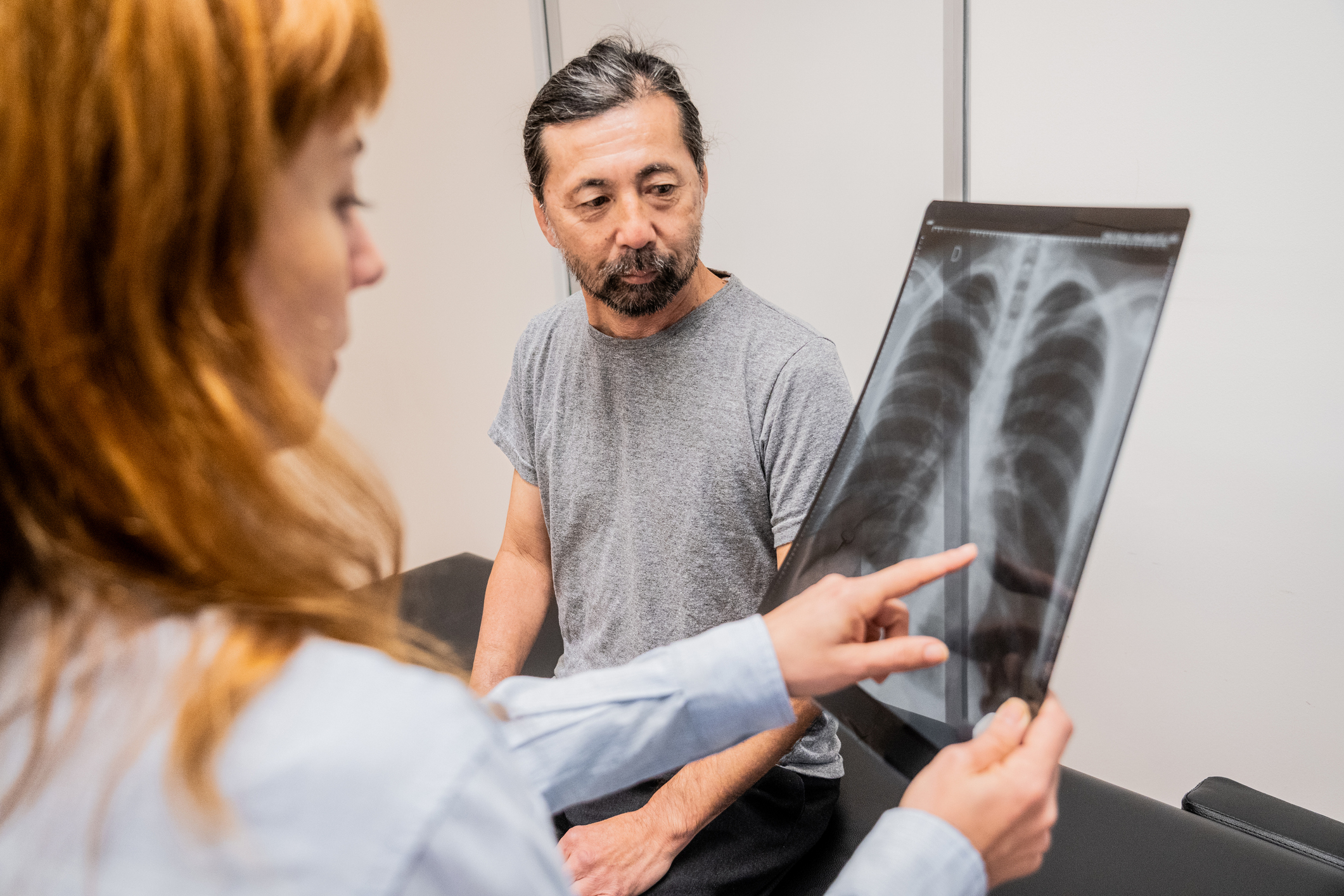 Female doctor showing medical exam to patient in a doctor's office