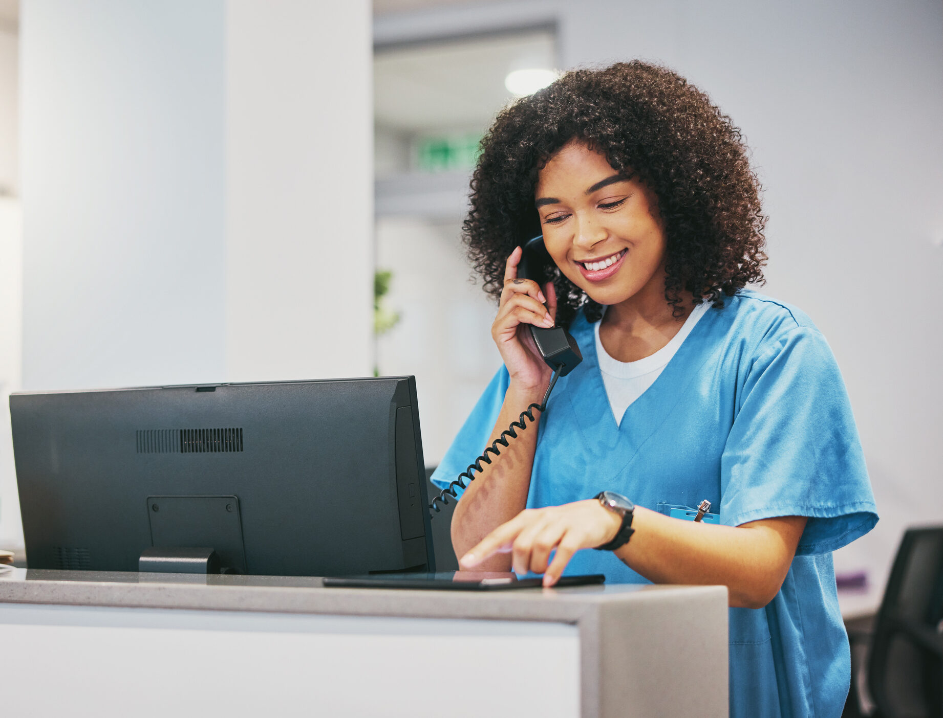Nurse, phone call and tablet of black woman at hospital with a smile. Clinic doctor, healthcare worker and networking of a young person happy about work conversation and health insurance talk