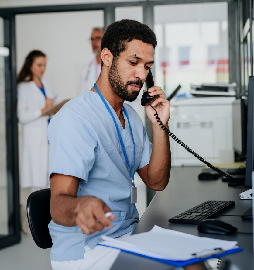 Portrait of young doctor working in the hospital reception.