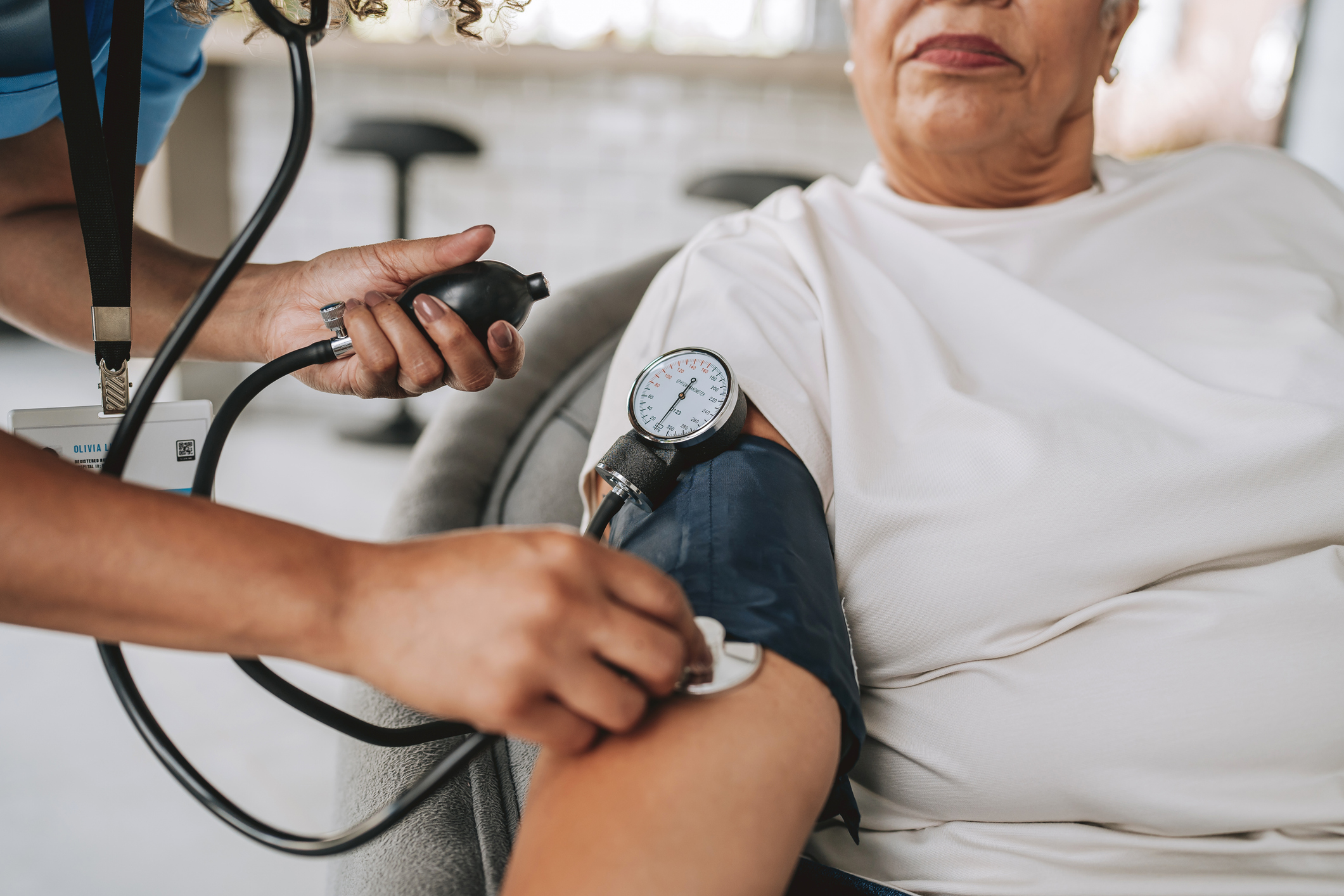 Home care healthcare worker measuring blood pressure