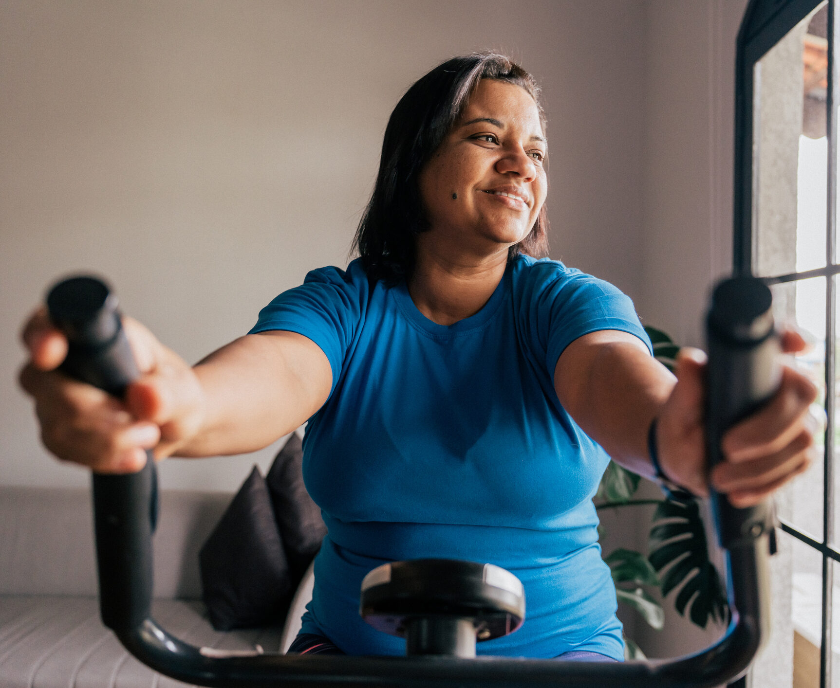Diabetic woman exercising on a bike at home