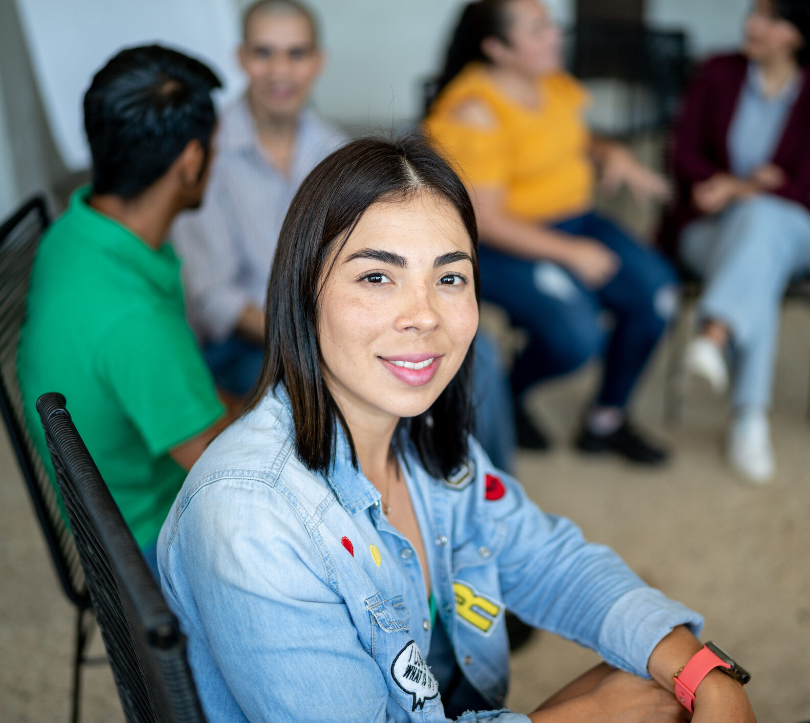 Portrait of mid adult woman during a group therapy at mental health center