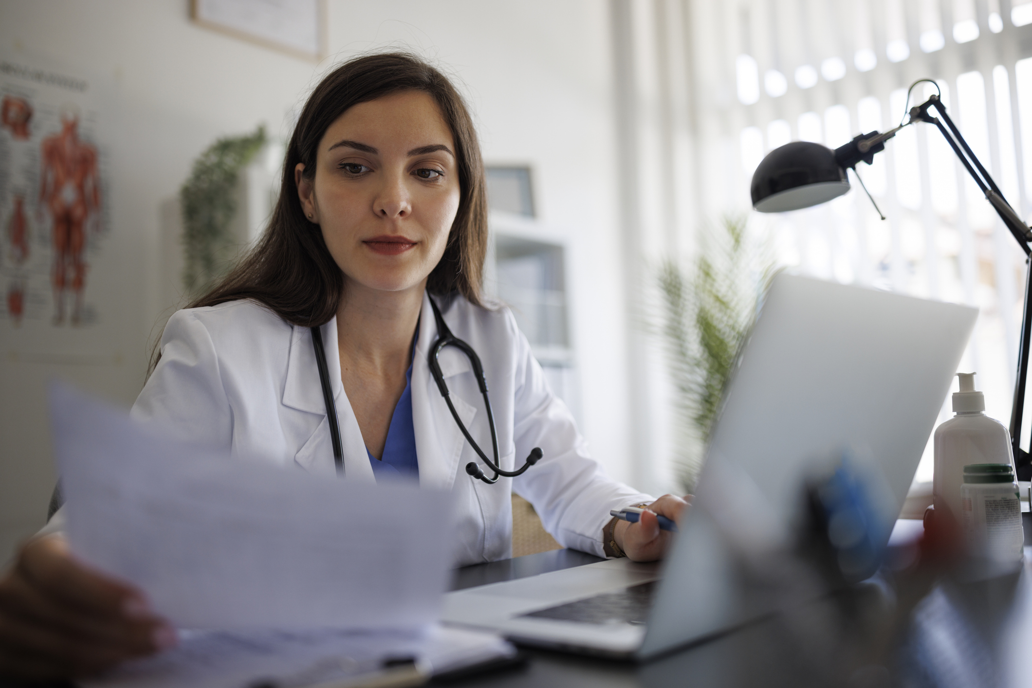 Female doctor working on laptop in the office
